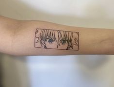 a person's arm with an anime tattoo on it