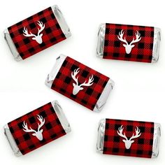 four red and black plaid reindeer head candy wrappers with white antlers on them