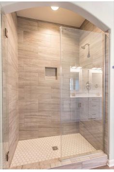 a walk in shower sitting inside of a bathroom