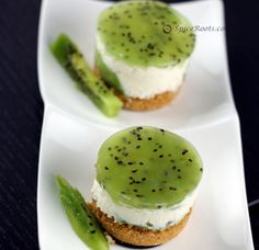 three small desserts with green and white frosting on them, one has a cucumber in the middle