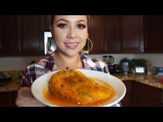 a woman holding a plate with food on it