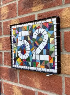 a brick wall with a stained glass heart on it