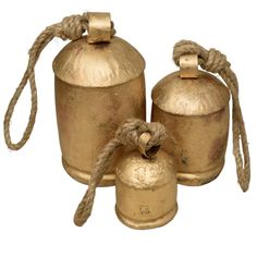 three brass bell shaped objects with rope on each side and two smaller bells in the middle