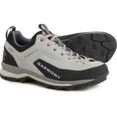 the men's hiking shoe is white and black with grey laces on it