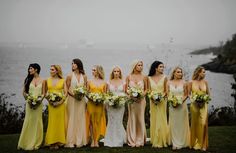 a group of women standing next to each other on top of a lush green field