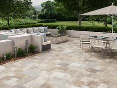 an outdoor patio with tables, chairs and umbrellas