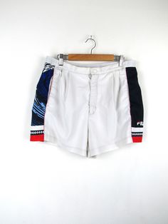 Fila vintage 90s tennis shorts, white with blue, red and white side bands Made in Italy Size L (pay attention to the measurements!) Measures Waist width: 42cm Thigh width: 34cm Crotch height: 30cm Total length: 38cm Condition: It is in excellent condition, it only has some small stains on the back and the "F" in Fila is slightly worn Our garments are all vintage and second hand. Any signs of wear or defects are documented with photos and description. For any questions, photos, videos we are at y Summer Tennis Athletic Shorts, White Tennis Shorts For Summer, White Summer Tennis Shorts, Sporty White Tennis Shorts, White Sporty Tennis Athletic Shorts, Sporty White Athletic Shorts For Tennis, White High-waisted Athletic Shorts With Built-in Shorts, White Tennis Shorts, Summer Tennis Bottoms Short Length