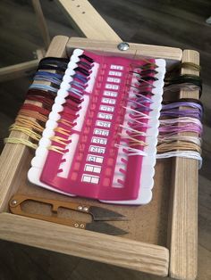 a wooden table topped with lots of different types of scissors