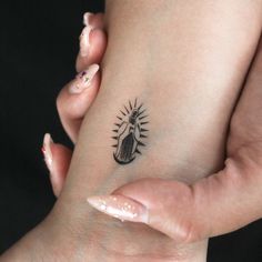 a woman's foot with a small tattoo on it