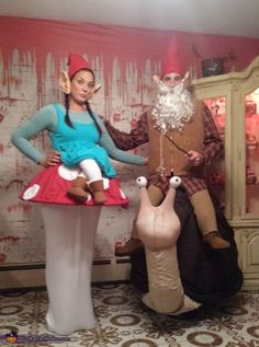 two people dressed up as gnomes and a man in a costume standing next to each other