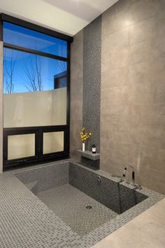 a bathroom with a large window and tiled floor