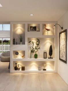 a living room filled with lots of furniture and lighting on top of white shelving