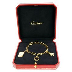 Circa 2000s, 18k, by Cartier, France. Timeless and tailored, this Cartier charm bracelet is the perfect everyday gold bracelet. Dressed for cocktails or effortlessly casual, it lays comfortably on the wrist. Festooned with a miniature trinity ring, a diamond-set cross or plus sign, and a love letter complete with a place to write a message in marker or engrave a permanent sentiment, it is perfect as is or add more Cartier charms to suit. Exquisitely made with the distinctive quality that Cartier Everyday Gold Bracelet, Plus Sign, Trinity Ring, Monogram Bracelet, Cartier Bracelet, Modern Bracelets, Gold Armband, A Love Letter, Diamond Set