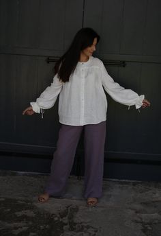 Slow fashion is about comfort, durability & versatility and there is no better way to do so than with this vintage style linen blouse with puffy sleeves -  VICTORIA. It is suitable for all seasons and you will love to wear this shirt all year round. It is timeless and versatile, can be easily mix and match with other clothes. Whether you are wearing this poet button up linen shirt to a special occasion or a casual day out, this shirt is sure to make you feel gorgeous and feminine. The puffy sleeves will give it a romantic and dreamy look that is sure to turn heads. DETAILS: Handmade from 100% pre-washed and softened linen. Oversized, button up design. Relaxed silhouette Puffy balloon sleeves Natural shell buttons COLOUR: White Other colour available to select from the colour pallet picture Long Sleeve Linen Peasant Top For Spring, Casual Linen Blouse With Balloon Sleeves, Bohemian Linen Blouse For Daywear, Long Sleeve Linen Peasant Top For Daywear, Peasant Style Long Sleeve Linen Top, Bohemian Long Sleeve Linen Peasant Top, Peasant Long Sleeve Linen Tops, Long Sleeve Linen Peasant Top, Linen Blouse With Lantern Sleeves