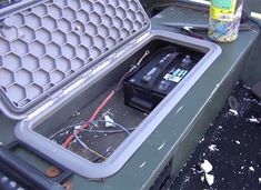 the inside of a large metal container with wires and other items in it on top of a table