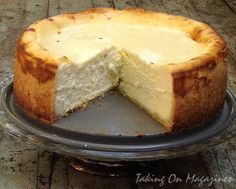 a cheesecake on a plate with one slice cut out and ready to be eaten