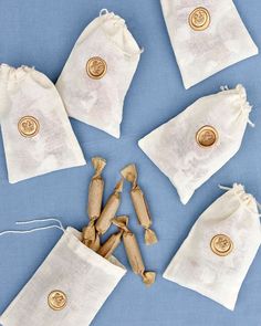 four bags with buttons on them are sitting next to some cinnamon sticks and two draws