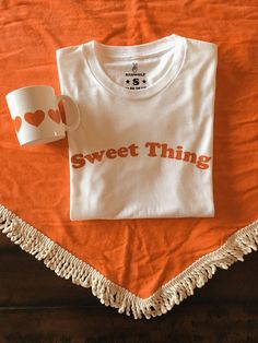 Sweet Thing Tee Sweet White Crew Neck Top, Sweet White Short Sleeve T-shirt, Sweet White Cotton T-shirt, Red Crew Neck T-shirt, White Sweet T-shirt With Funny Print, Sweet White T-shirt With Funny Print, Sweet White T-shirt With Graphic Print, Red Sweet Crew Neck T-shirt, Sweet Style Red Crew Neck T-shirt