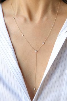 14k gold and diamond lariat necklace with .50 total carat weight of white diamonds. Six round white diamonds. 20" around the neck with a 3" drop. A delicate and timeless piece for everyday wear. Dainty Cubic Zirconia Lariat Necklace, Delicate Lariat Cubic Zirconia Necklace, Delicate Cubic Zirconia Lariat Necklace, Diamond Lariat Necklace With Clavicle Chain, Cubic Zirconia Lariat Necklace With Diamond Accents, Diamond Lariat Necklace With Long Drop, Lariat Necklace With Diamond Accents, Delicate Diamond Lariat Necklace With Adjustable Chain, Dainty Diamond Lariat Necklace