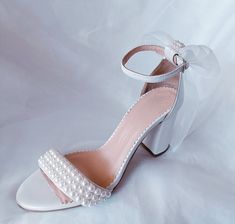 Introducing our exquisite and comfortable wedding sandals, meticulously crafted with the elegant bride in mind. Handmade with utmost care and attention to detail, these wedding pearl heels are the epitome of grace and sophistication. Our Wedding Shoes are designed to capture the essence of romance and enchantment. The delicate organza bow, adds a touch of ethereal charm to these ivory pearl block heels. These comfort shoes are specifically created to ensure that you can dance the night away with ease and grace on your special day. The block heel provides stability and support, allowing you to confidently navigate any terrain. The soft leather lining adds a luxurious feel, pampering your feet with each step you take. Key Features: *Made to order *Elegant and timeless design *Handcrafted wit Elegant Open Toe Sandals For Bridesmaids, Elegant Pearl Embellished Block Heels, Elegant Low Heel Bridesmaid Heels, Elegant Ankle Strap Wedding Shoes For Bridesmaids, Summer Wedding Shoes With Block Heel, Elegant Closed Toe Bridal Accessories For Bridesmaid, Feminine Open Toe Wedding Shoes With 4-inch Heel, Elegant Summer Wedding Shoes For Bridesmaids, Elegant Pearl-embellished Open Toe Sandals