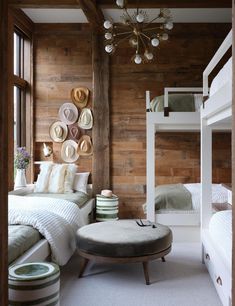 a bedroom with bunk beds and wooden walls