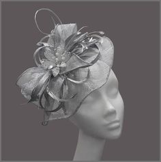 Ladies metallic silver disc fascinator (hatinator) with sinamay loops, feathers and a gorgeous crystal flower centre. Made on a headband. This design can be made to order, please contact us for details. Perfect for a tea party, wedding (mother of the bride), race day or for a special occasion. Designs can be made to order in a range of different colours or styles, see our colour chart: www.jacquivaledesigns.com/colour_chart.html Please contact me if you would like a design in a different colour. Gold Fascinator, Red Fascinator, Tea Party Hats, Wedding Fascinators, Crystal Headband, Flower Center, Wedding Headband, Fascinator Hats, Wedding Hats