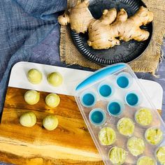 a cutting board with some cut up food on it and a plate full of sliced ginger