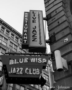 a black and white photo of the blue wish jazz club sign in new york city