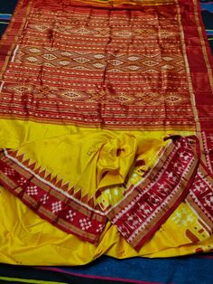 ###Be vocal For Local### Material : 3 ply Mulberry silk  yellow and red combination  without Blouse piece Tribal pasapale border khandua silk  Length of Saree : 5.5 meters Occasion: Festive , Party, Ceremony. Free Falls and piko Wash Care : Dry Cleaning ; Dry on Clean Horizontal Surface Under Shade So add it in your wardrope and drape them for office parties and local parties Disclaimer: 1. Since the size above is measured by hand, the size of the actual item you received could be slightly different from the size mentioned above. 2. Please be reminded that due to lighting effects, monitor's brightness/contrast settings etc, there could be some slight differences in the color tone of the pictures and the actual item. 3. Import duties, taxes, and charges are not included in the item price or Festive Yellow Silk Saree, Yellow Tussar Silk Dupatta With Border, Yellow Silk Saree With Pallu, Yellow Silk Saree For Puja, Yellow Katan Silk Traditional Wear With Border, Yellow Tussar Silk Saree With Border, Silk Traditional Wear With Border For Puja, Yellow Katan Silk Saree With Border, Yellow Silk Dupatta With Border