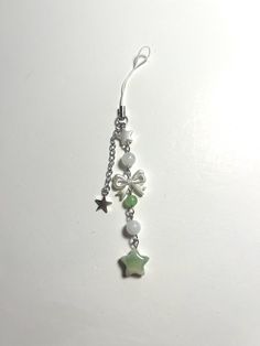 a pair of dangling earrings with stars and beads