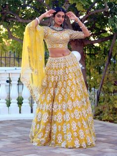 Go all out in this whimsical lehenga, studded with precious mirror, pearl, stone, embroidery work, which is sure to bring out the innate grace and grandeur in you! Color - Chrome Yellow Fabric & Work Style - - Silk blouse: mirror, pearl, stone, embroidery work. - Soft net lehenga: mirror, pearl, stone, embroidery work. - Soft net dupatta: embroidery work. Details - - Assured quality - Wash care instruction: Dry clean only. - Slight variation in color is possible due to digital photography. Bridal Lehenga Indian, Bridal Jewelry Indian, Indian Bridal Couture, Dupatta Embroidery, Lehenga Indian, Stone Embroidery, Indian Bridal Jewelry, Fabric Work, Indian Bridal Lehenga