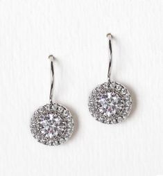 pair of diamond earrings on white background