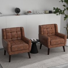 two brown chairs sitting next to each other on top of a carpeted room floor