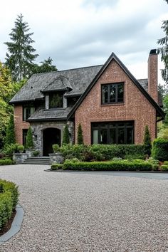 a large brick house surrounded by trees and bushes