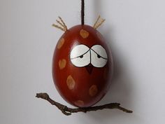 an egg painted like a bird on a branch