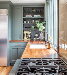 a kitchen with an oven, sink and counter tops in it's center island