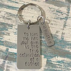 a keychain with a quote on it that says to love me like your giving is the definition of a father