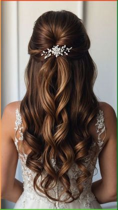 the back of a woman's head with long wavy hair and flowers in her hair