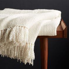 a white blanket sitting on top of a wooden table