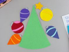 the paper ornaments are cut out and placed on the table next to markers, pencils and marker pens