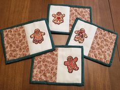 four coasters with teddy bears on them sitting on a wooden floor next to each other