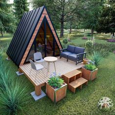 a - frame cabin in the middle of a grassy area with furniture and plants around it