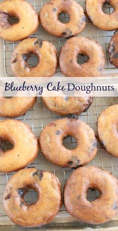 blueberry cake doughnuts on a cooling rack with the words blueberry cake doughnuts above them