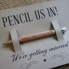 a pencil is laying on top of a piece of paper with the words, we're getting married