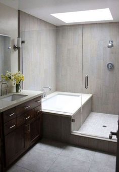 a bathroom with a tub, sink and shower stall in the middle of it's walls