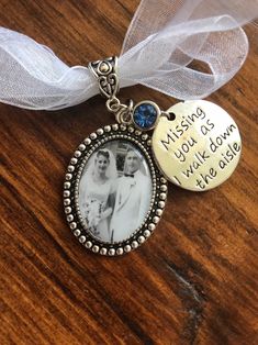 a necklace with an image of two women and the words missing you're down