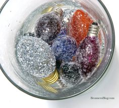 a glass bowl filled with different colored balls