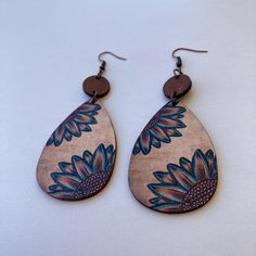 These Handmade Sunflower Wood Teardrop Boho Dangle Earrings are a beautiful combination of natural wood texture and an eye-catching sunflower design. With their lightweight, eco-friendly material, these earrings are ideal for those who appreciate bohemian, ethnic, or minimalist fashion styles. They're perfect for anyone looking for a simple, yet unique, accessory that complements both casual and more creative, free-spirited outfits. Crafted from high-quality natural wood, these earrings feature copper hooks that are gentle on the skin. The wood's natural grain gives each pair a unique texture, while the copper hooks add durability and an earthy charm. Measuring 9 cm in length (3.54 inches) and 3.7 cm in width (1.46 inches), they're lightweight and comfortable for all-day wear. The eco-frie Bohemian Brown Teardrop Earrings Gift, Bohemian Brown Teardrop Earrings For Gift, Handmade Brown Bohemian Teardrop Earrings, Bohemian Brown Dangle Flower Earrings, Bohemian Brown Flower Earrings, Bohemian Brown Teardrop Earrings, Bohemian Brown Teardrop Earrings For Pierced Ears, Brown Bohemian Drop Flower Earrings, Handmade Brown Bohemian Flower Earrings