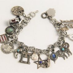 Vintage Sterling Silver Charm Bracelet With At Least 13 Sterling Charms With Travel Theme. Charms Include A Sand Dollar, Monaco Flag, Cowboy Boot, Asian Temple Gate And More. 7". Weight: 33.9". Monaco Flag, Asian Temple, Vintage Sterling Silver Charms, Travel Theme, Sterling Silver Charm Bracelet, Silver Charm Bracelet, Sand Dollar, Cowboy Boot, Travel Themes