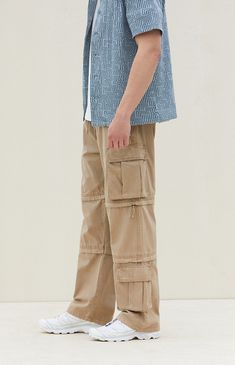 Experience ultimate versatility and durability with PacSun's Tan Baggy Cargo Zip-Off Pants. Crafted from cotton with a drawstring waistline, these pants boast ample storage with side and cargo pockets, while offering the convenience of zip-off legs for instant shorts transformation. Finished with additional cargo pockets near the hem, they ensure both style and functionality for your adventurous outings. Full Length Cotton Cargo Jeans With Elastic Waistband, Outdoor Khaki Cotton Cargo Jeans, Cotton Cargo Jeans With Multiple Pockets For Outdoor Activities, Urban Cotton Cargo Pants For Outdoor Activities, Urban Cotton Cargo Pants For Outdoor, Outdoor Cotton Cargo Jeans With Pockets, Cotton Cargo Jeans For Outdoor, Baggy Cotton Cargo Jeans For Outdoor, Urban Style Cotton Cargo Pants For Outdoor